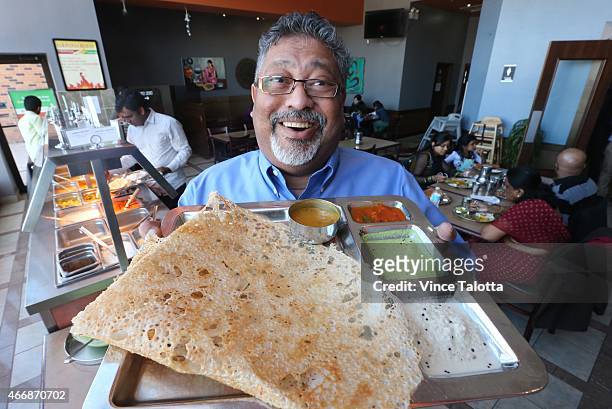 At his Scarborough restaurant, Ganesan Sugumar, CEO/Director of Saravanaa Bhavan, Canada holds up a dish called Rava dosa from South India, the same...