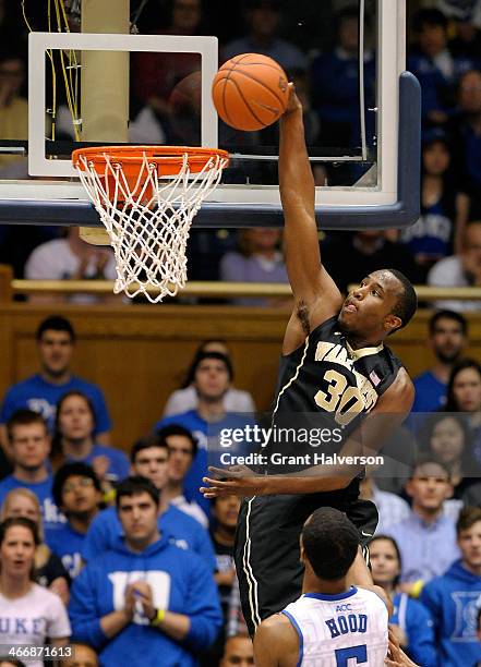 Travis McKie of the Wake Forest Demon Deacons dunks over Rodney Hood of the Duke Blue Devils during their game at Cameron Indoor Stadium on February...