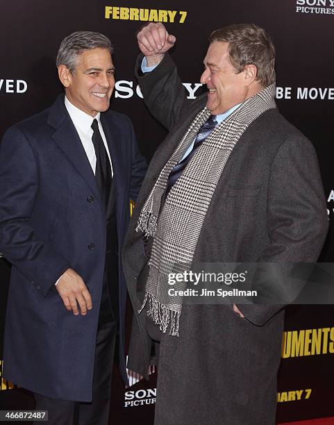 Actor/director George Clooney and actor John Goodman attends "The Monuments Men" premiere at Ziegfeld Theater on February 4, 2014 in New York City.