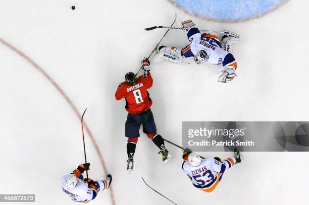 Goalie Evgeni Nabokov of the New York Islanders makes a save on Alex Ovechkin of the Washington Capitals in the third period at the Verizon Center on...