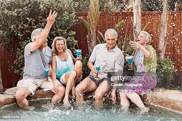 group of seniors splashing in the hot tub - hot tub party stock pictures, royalty-free photos & images