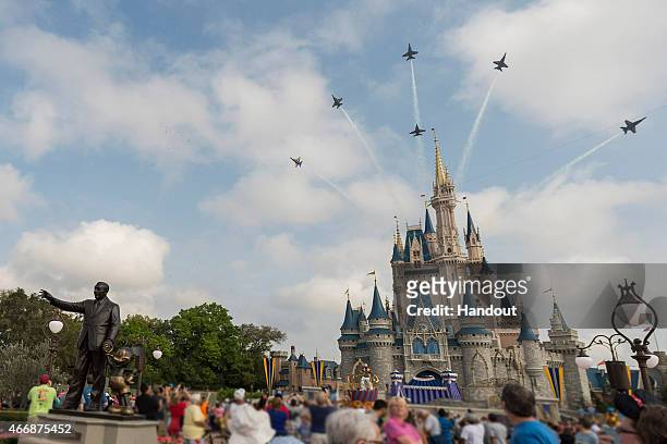 In this handout photo provided by Disney Parks, in a special moment for Magic Kingdom guests, the U.S. Navy Flight Demonstration Squadron, the Blue...