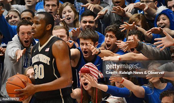 Cameron Crazies taunt Wake Forest forward Travis McKie as he inbounds the ball in the first half of play. The Duke Blue Devils defeated the Wake...
