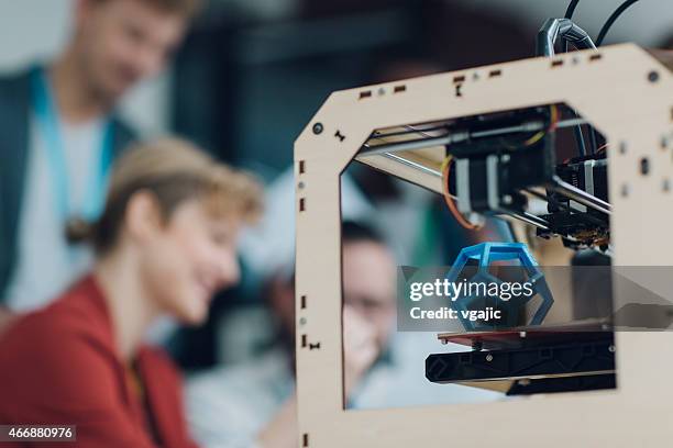 creative start-up business team working by 3d printer. - 3d printer female stockfoto's en -beelden