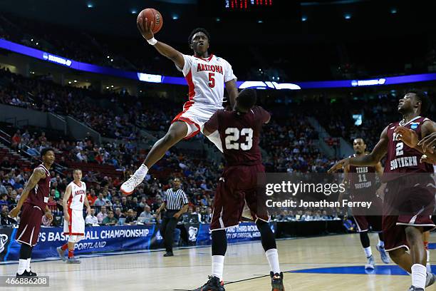 Stanley Johnson of the Arizona Wildcats puts up a shot over Jason Carter of the Texas Southern Tigers in the first half during the second round of...