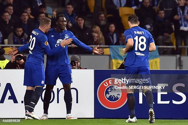 Everton's Belgian forward Romelu Lukaku celebrates with teammates after scoring a goal during the UEFA Europa League round of 16 football match...