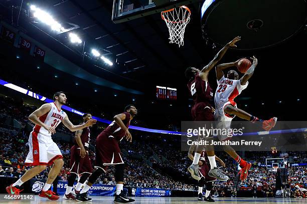 Rondae Hollis-Jefferson of the Arizona Wildcats puts up a shot as he is defended by Chris Thomas of the Texas Southern Tigers in the first half...