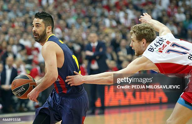 Barcelona's guard Juan Carlos Navarro fights for the ball with Crvena Zvezda Belgrade's Slovenian guard Jaka Blazic on March 19, 2015 during a...