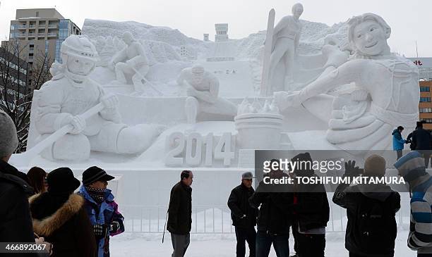 Tourists visit a huge snow statue entitled "Winter Sports Paradise, Hokkaido" during the 65th annual Sapporo Snow Festival on February 5, 2014. The...