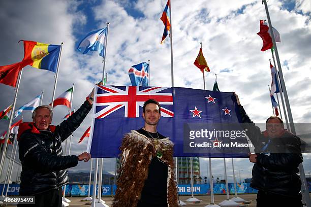 Cloaked with Te Mahutonga, speed skater and New Zealand flag bearer Shane Dobbin poses in front of the New Zealand national flag next to Chef de...
