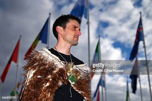 Cloaked with Te Mahutonga, speed skater and New Zealand flag bearer Shane Dobbin listens during a ceremony ahead of the Sochi 2014 Winter Olympics at...