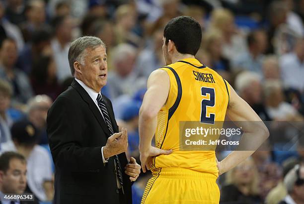 California Golden Bears head coach Mike Montgomery talks with Sam Singer against the UCLA Bruins at Pauley Pavilion on January 26, 2014 in Los...