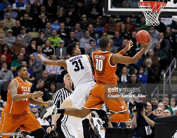 Jonathan Holmes of the Texas Longhorns shoots against Kameron Woods of the Butler Bulldogs in the first half during the second round of the 2015 NCAA...