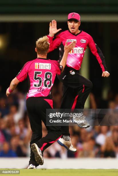 Marcus North and Brett Lee of the Sixers celebrate getting the wicket of Sam Whiteman of Perth during the Big Bash League semi final match between...