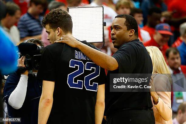 Head coach Ron Hunter of the Georgia State Panthers puts his arm around son and player R.J. Hunter after the Panthers 57-56 win against the Baylor...