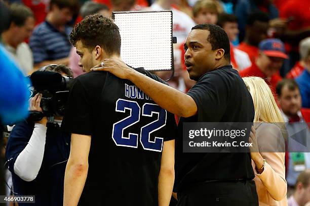 Head coach Ron Hunter of the Georgia State Panthers puts his arm around son and player R.J. Hunter after the Panthers 57-56 win against the Baylor...