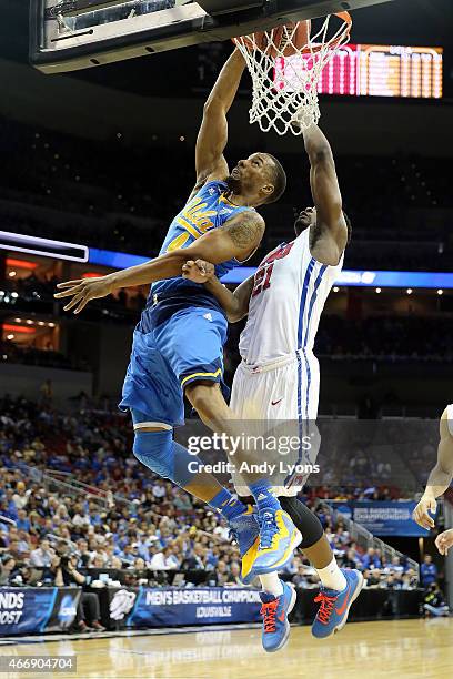 Norman Powell of the UCLA Bruins dunks the ball against Ben Emelogu of the Southern Methodist Mustangs during the second round of the 2015 NCAA Men's...