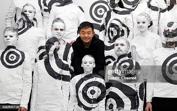 Chinese artist Liu Bolin poses with his last artwork at the galerie Paris-Beijing on March 19, 2015 in Paris, France. Liu Bolin is Internationally...