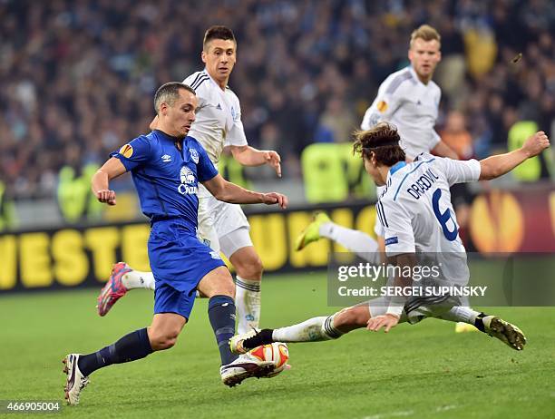 Dynamo Kiev's Aleksandar Dragovic and Everton FC's Leon Osman vie for the ball during the UEFA Europa League round of 16 football match between...