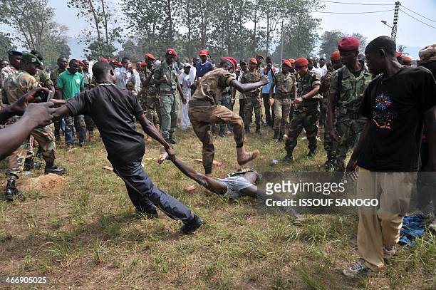 Members of the Central African Armed Forces lynch a man suspected of being a former Seleka rebel on February 5 in Bangui. The impoverished former...