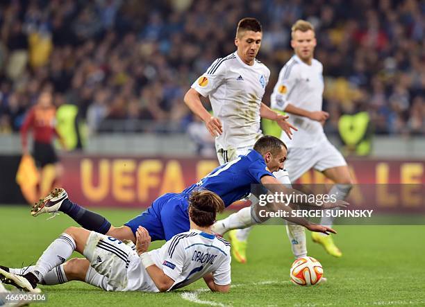 Dynamo Kiev's Aleksandar Dragovic and Everton FC's Leon Osman vie for the ball during the UEFA Europa League round of 16 football match between...