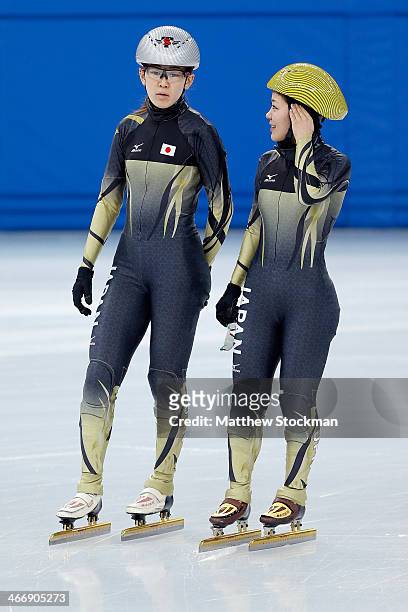 Short track speed skaters Sayuri Shimizu and Biba Sakurai of Japan talk during a training session ahead of the Sochi 2014 Winter Olympics at the...