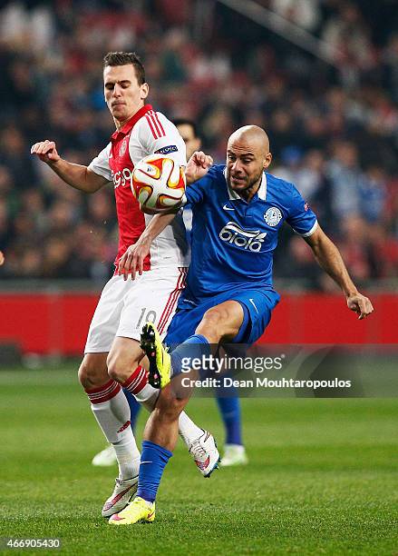 Arkadiusz Milik of Ajax and Dzhaba Kankava of Dnipro compete for the ball during the UEFA Europa League Round of 16, second leg match between AFC...