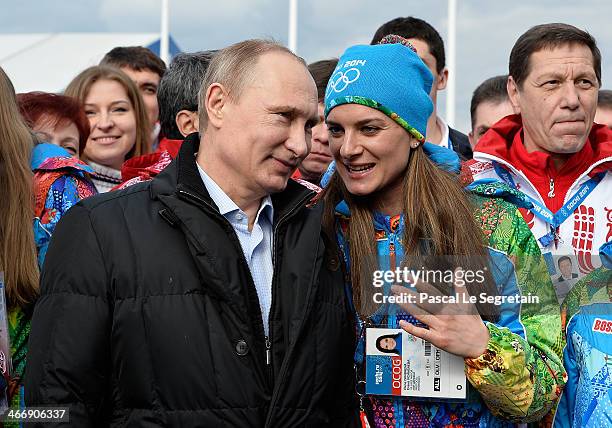Russian President Vladimir Putin speaks with Olympic Village Mayor Elena Isinbaeva while visiting the Coastal Cluster Olympic Village ahead of the...