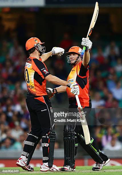Craig Simmons of the Scorchers celebrates scoring a century with Mitch Marsh during the Big Bash League semi final match between the Sydney Sixers...