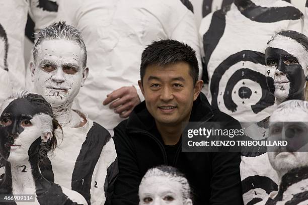 Chinese artist Liu Bolin takes part in a performance on March 19, 2015 in Paris. AFP PHOTO / KENZO TRIBOUILLARD RESTRICTED TO EDITORIAL USE,...