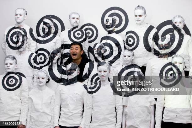 Chinese artist Liu Bolin takes part in a performance on March 19, 2015 in Paris. AFP PHOTO / KENZO TRIBOUILLARD RESTRICTED TO EDITORIAL USE,...