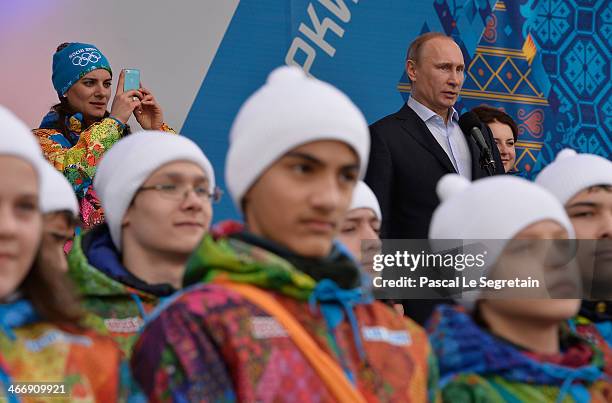 Russian President Vladimir Putin speaks during a visit to the Coastal Cluster Olympic Village as Olympic Village Mayor Elena Isinbaeva takes a...