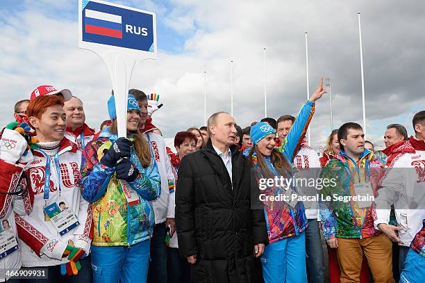 Russian President Vladimir Putin poses with Olympic Village Mayor Elena Isinbaeva and Russian athletes while visiting the Coastal Cluster Olympic...