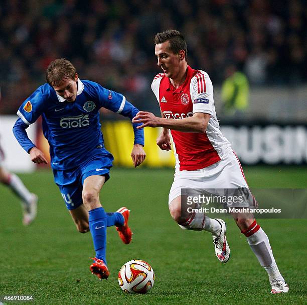 Arkadiusz Milik of Ajax is pursued by Valeriy Luchkevych of Dnipro during the UEFA Europa League Round of 16, second leg match between AFC Ajax v FC...