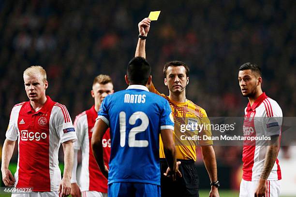Leo Matos of Dnipro is shown the yellow card by referee Aleksei Kulbakov of Belarus during the UEFA Europa League Round of 16, second leg match...