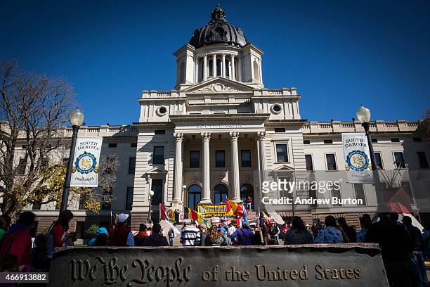 People participate in a protest against the proposed Keystone XL pipeline on October 13, 2014 in Pierre, South Dakota. Numerous Native American...
