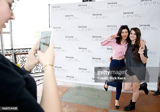 Singer/songwriter Marina Diamandis poses with a fan during the Marina & the Diamonds album listening session at the Samsung Studio at SXSW 2015 on...