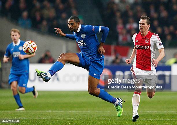 Douglas Bacelar of Dnipro controls the ball as Arkadiusz Milik of Ajax closes in during the UEFA Europa League Round of 16, second leg match between...