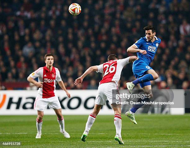 Nikola Kalinic of Dnipro rises above Nick Viergever of Ajax to direct a header on goal during the UEFA Europa League Round of 16, second leg match...