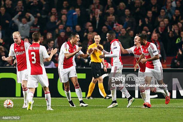 Riechedly Bazoer of Ajax celebrates with teammates after scoring a goal to level the scores at 1-1 on aggregate during the UEFA Europa League Round...