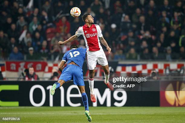 Ajax Amsterdam's Dutch forward Ricardo Kishna jumps to head the ball with Dnipro Dnipropetrovsk's Brazilian defender Leo Matos during the UEFA Europa...