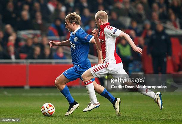 Valeriy Luchkevych of Dnipro is pursued by Davy Klaassen of Ajax during the UEFA Europa League Round of 16, second leg match between AFC Ajax v FC...