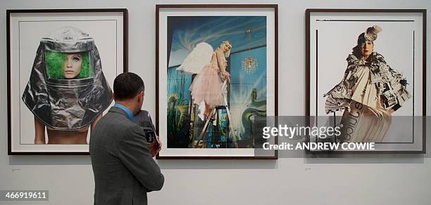 Visitor looks at photographs by British photographer David Bailey of Abby Lee Kershaw, Cicciolina and Anna Piaggi at an exhibition of his works where...