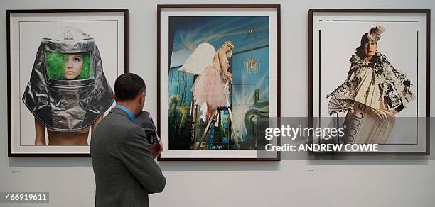 Visitor looks at photographs by British photographer David Bailey of Abby Lee Kershaw, Cicciolina and Anna Piaggi at an exhibition of his works where...