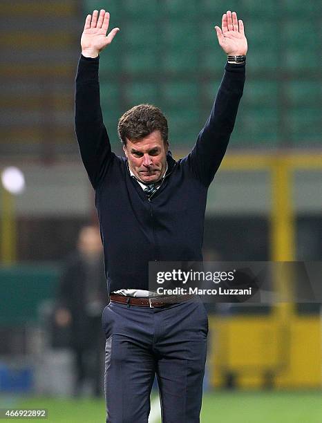 VfL Wolfsburg coach Dieter Hecking salutes the fans at the end of the UEFA Europa League Round of 16 match between FC Internazionale Milano and VfL...