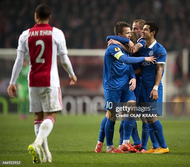 Dnipro Dnipropetrovsk's Ukrainian midfielder Yevhen Konoplyanka celebrates with teammates after scoring a goal during the UEFA Europa League round of...