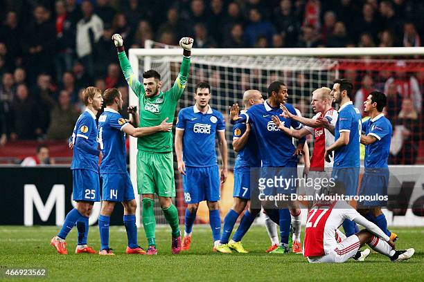 Dnipro players celebrate as they advance to the next round on away goals during the UEFA Europa League Round of 16, second leg match between AFC Ajax...
