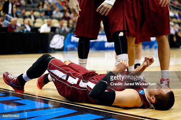 Joey Ptasinski of the Lafayette Leopards lays on the ground after fouling out JayVaughn Pinkston of the Villanova Wildcats in the first half during...