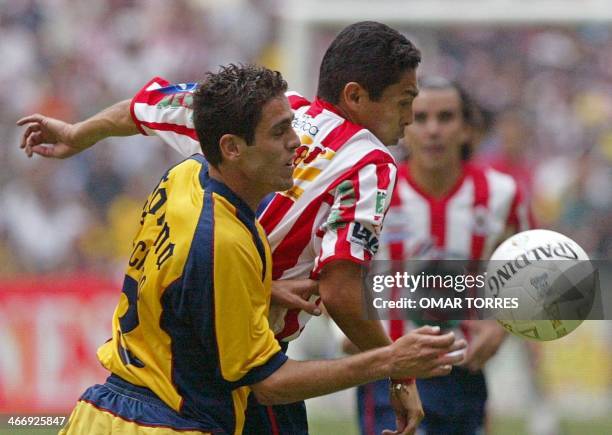 Jose Castro of America fights for the ball against Morales del Chivas of Guadalajara , 31 March 2002, in the Azteca stadium in Mexico City. Jose...