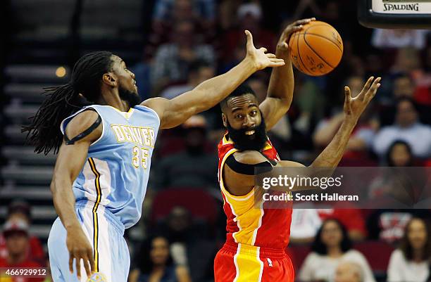 James Harden of the Houston Rockets battles for a rebound with Kenneth Faried of the Denver Nuggets during their game at the Toyota Center on March...